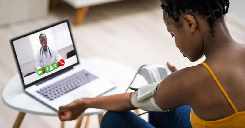 woman with blood pressure cuff around her arm